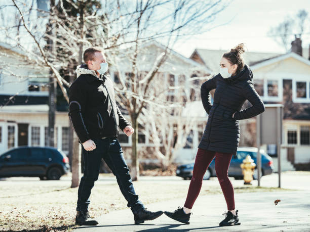 istock COVID-19, Young couple meeting outside 1214307496