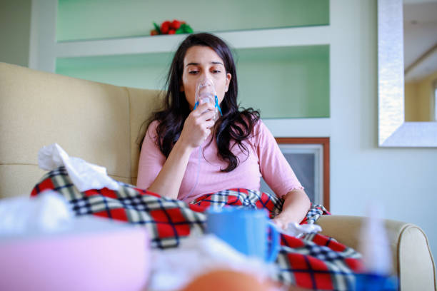 istock Young woman using an asthma inhaler- Coronavirus 1214307548