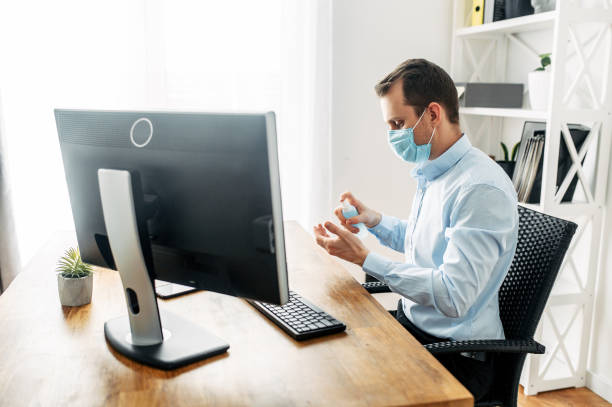 istock Man in a medical mask at the office 1214310510
