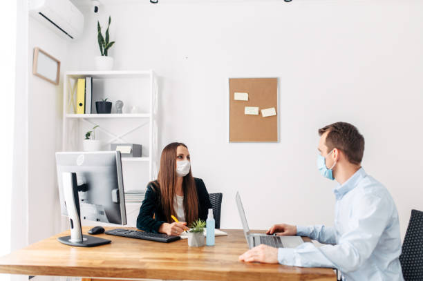 istock Office workers in medical masks during pandemia 1214310572