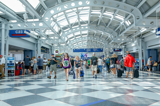 Chicago, USA - July 20, 2018: Travelers walk to gates at Chicago O'Hare International Airport in USA.