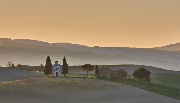 istock Sunrise sky over farm house and chapel 1214311681