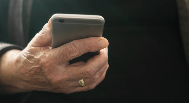 istock Old woman is using the phone 1214315252