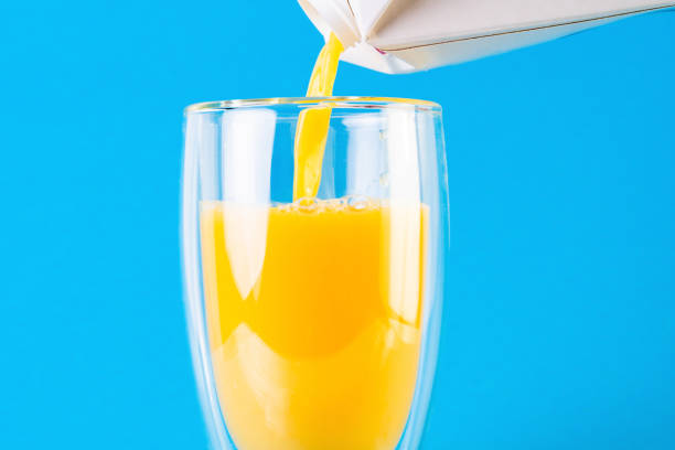 istock Pouring orange juice into a glass 1214315484