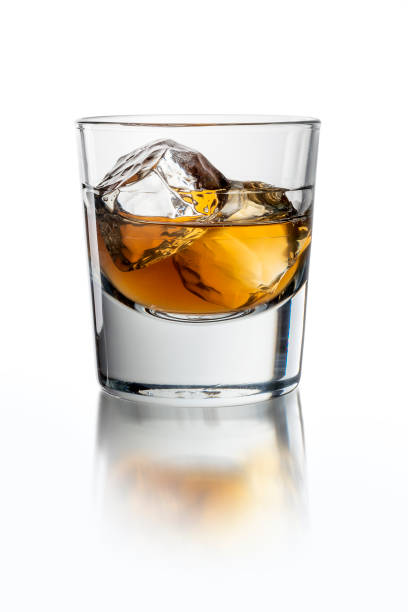 istock Glass with whiskey on the white background with ice 1214315780
