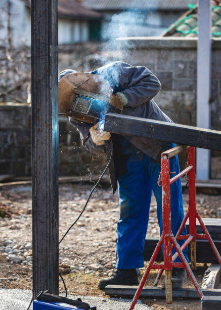 istock Socialism Worker Welding Outdoors 1214315819