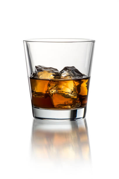 istock Glass with whiskey on the white background with ice 1214315834
