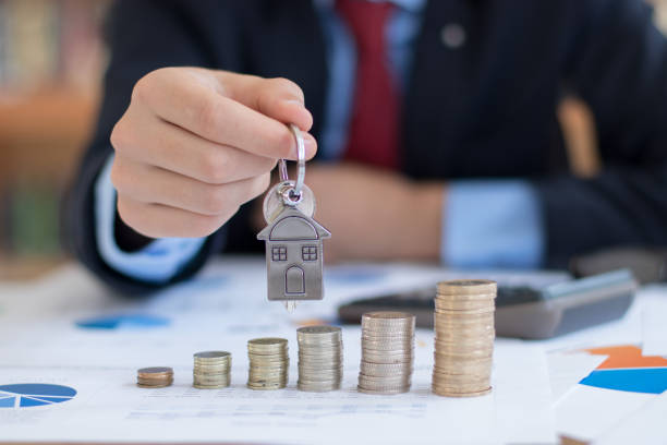 istock Real estate agent calculating 1214316858