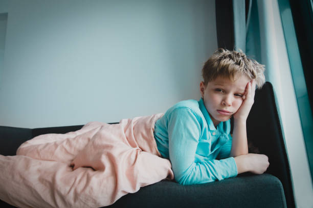 istock Sick child with infection or virus at home, self isolation 1214317554