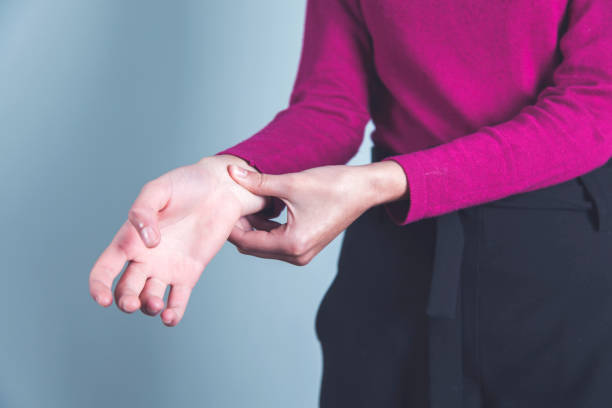 istock woman hand on ache hand 1214318694