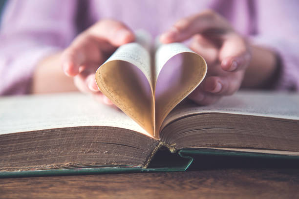 istock hand  heart on book paper 1214318887