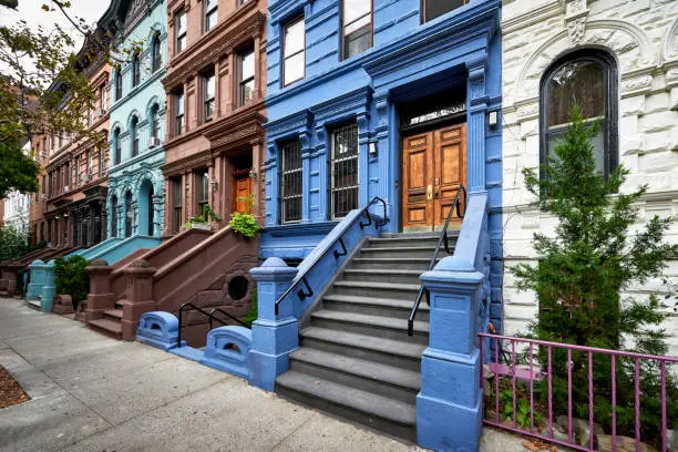 a colorful staircase leading up to a brownstone building