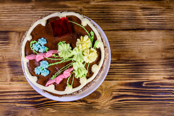istock Kiev cake with cream, nuts and meringue on a wooden table. Top view 1214319977