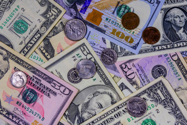 istock Different american cent coins over the dollar banknotes 1214321037