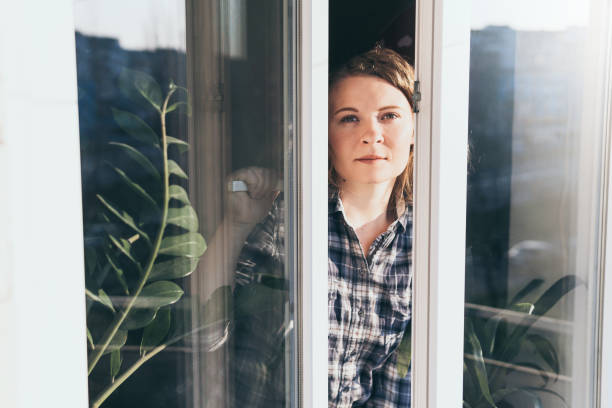 istock Young blonde woman opening a window 1214323515