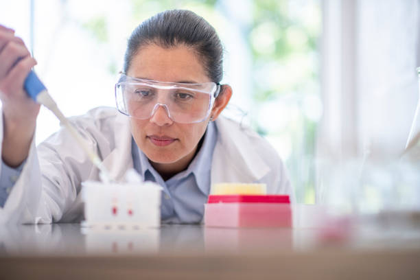 istock Female Biologist Using a Pipette stock photo 1214323588