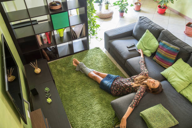 tired woman relaxing on a green carpet stock photo