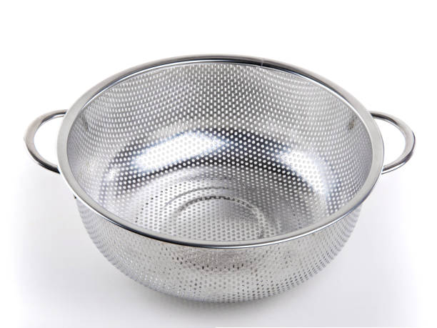 istock A middle metal colander on a white isolated background. Kitchen accessories. 1214325276
