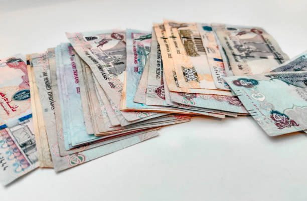 istock Money Spread on a white table | UAE Dirhams | United Arab Emirates currency | AED - Dhs | One hundred, five hundred, two hundreds and fifty bills 1214325442