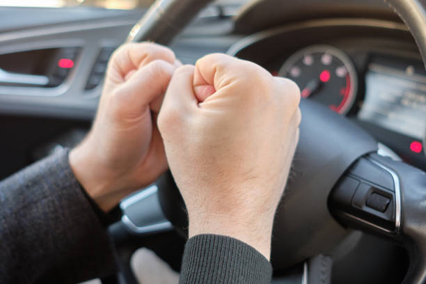 istock A man in a modern car. Hands hitting the steering wheel with anger. 1214325597