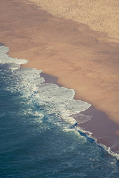 northern beach, nazare, portugal famous big wave beach praia do norte from above in nazare, portugal. nazare surf stock pictures, royalty-free photos & images