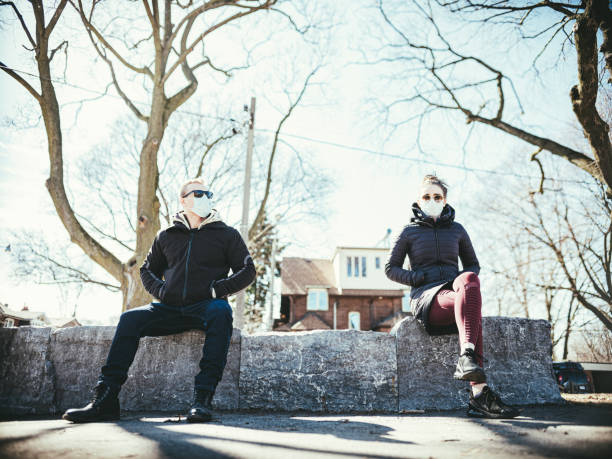 istock COVID-19, Young couple meeting outside 1214326609
