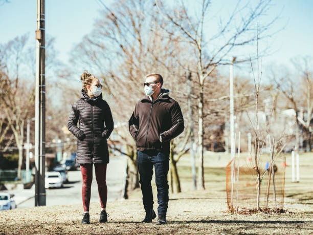 istock COVID-19, Young couple meeting outside 1214326705
