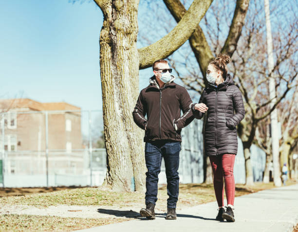 istock COVID-19, Young couple meeting outside 1214326716