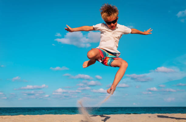 istock happy boy play on beach, kid enjoy sea vacation 1214326828