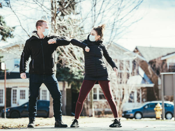 istock COVID-19, Young couple meeting outside 1214326831