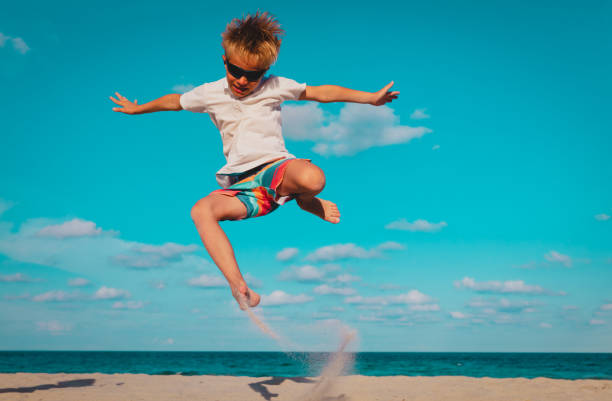 istock happy boy play on beach, kid enjoy sea vacation 1214327417