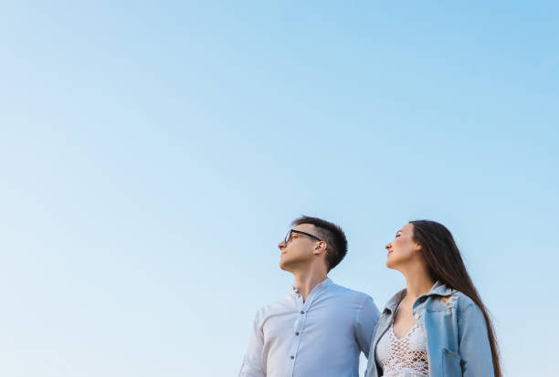 istock Loving couple on sky background. 1214327997