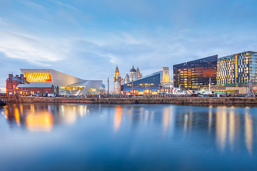 Skyline of downtown Liverpool with the Museum of Liverpool in England UK at twilight blue hour.