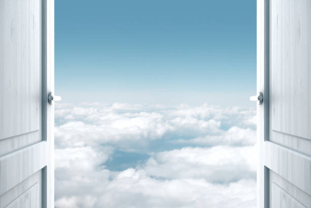 View from below, looking up to him and blue sky