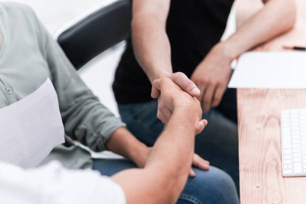 istock close up. welcome handshake business people in the office 1214330843