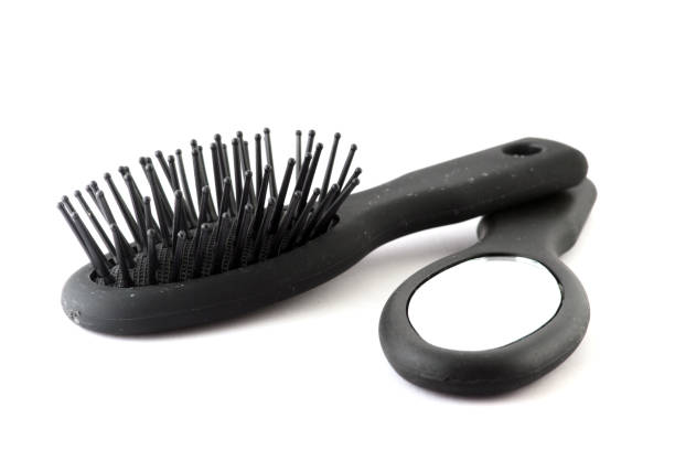 istock black plastic hair brush and looking-glass isolated on white background 1214331901