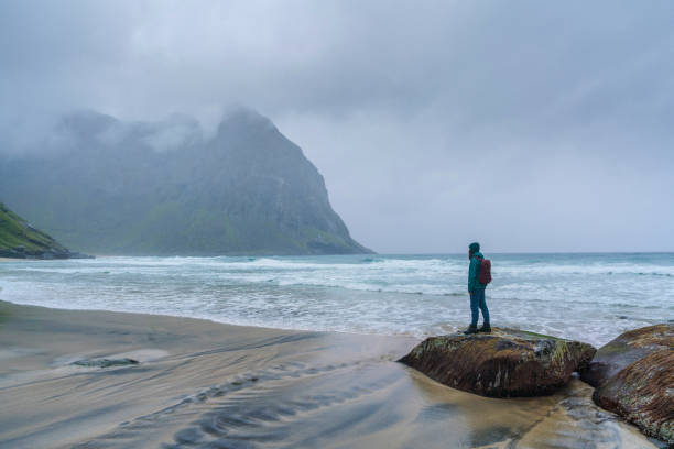 istock Woman standing on beach in Norway 1214332119