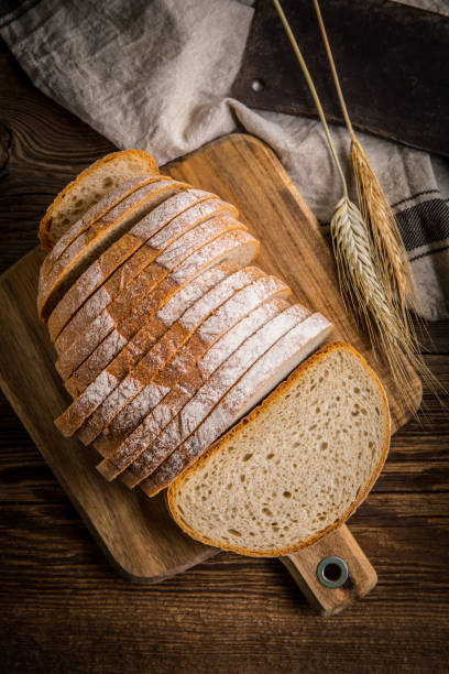 istock Sliced loaf of bread on a chopping board. 1214332354