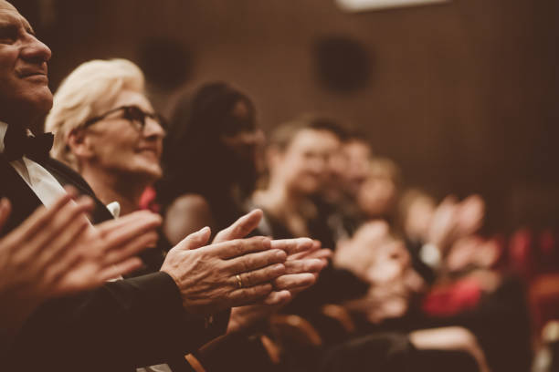 istock Senior people clapping in the theater, focus on hands 1214333105