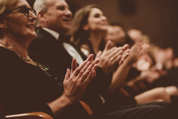 istock Senior people clapping in the theater, focus on hands 1214333412