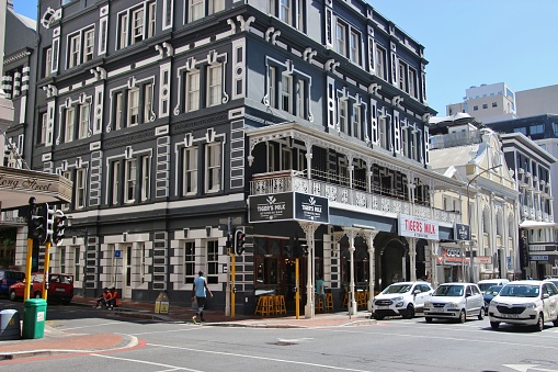 Cape Town, South Africa, Africa - February 18, 2020: Street scene with restaurant building on famous Long Street, lined by Victorian-style buildings with wrought-iron balconies.