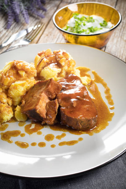 istock Braised pork neck in own sauce served with boiled potatoes. 1214335281
