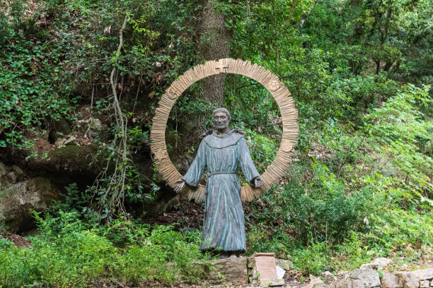 Study in DOF with foreground blurred and statue of St. Francis of Assissi in focus.