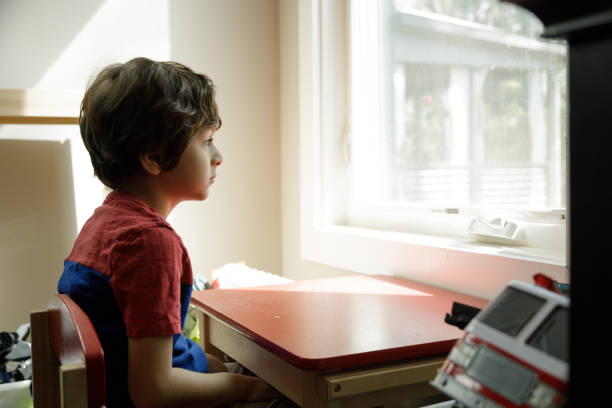 Little Boy Self-Isolation At Home stock photo