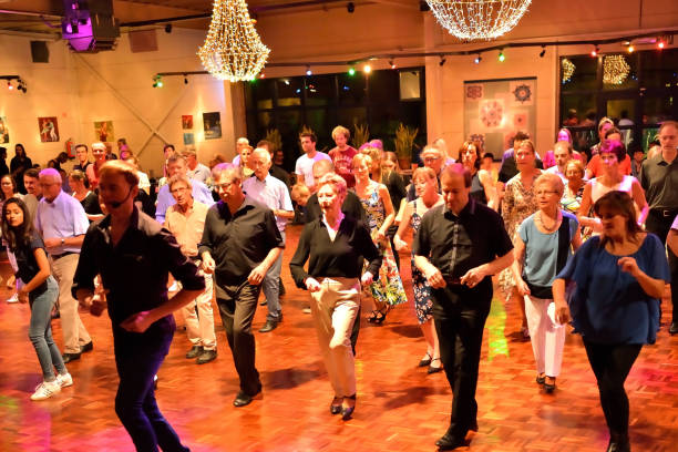 Workshop classes. Indoor line dancing by a professional instructor. Herent, Belgium - September 14, 2019: Open House indoor dancing classes evening show. Photo reportage open door promotion indoor dance classes. Courses starting half September. Teacher in front of group demonstrates solo dance. teacher retirement party stock pictures, royalty-free photos & images