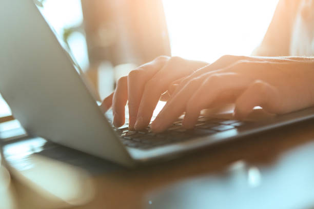 istock Young woman typing on laptop 1214336522