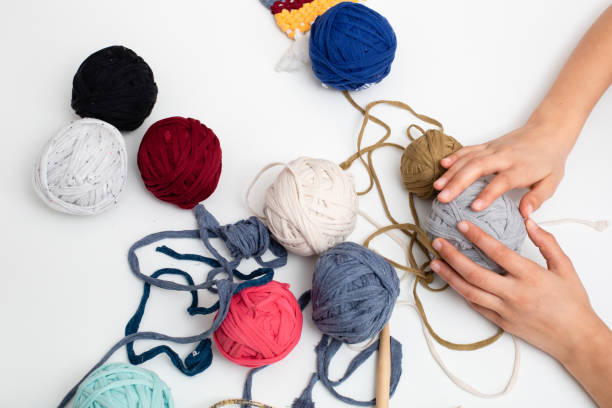 istock Colored balls of yarn on white table 1214336543