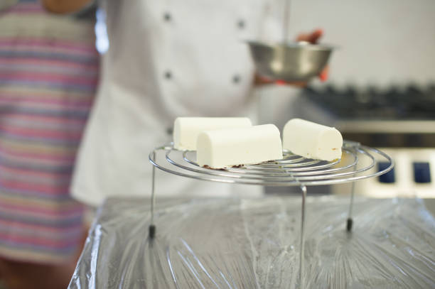 istock Creamy mousse dessert on a stand. The process of making dessert 1214336818