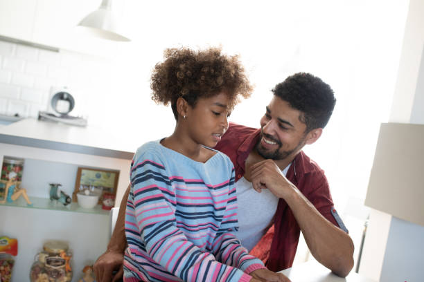 istock Father and daughter at home 1214337140