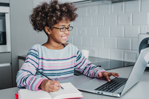 istock Young girl at home studying with laptop 1214337177